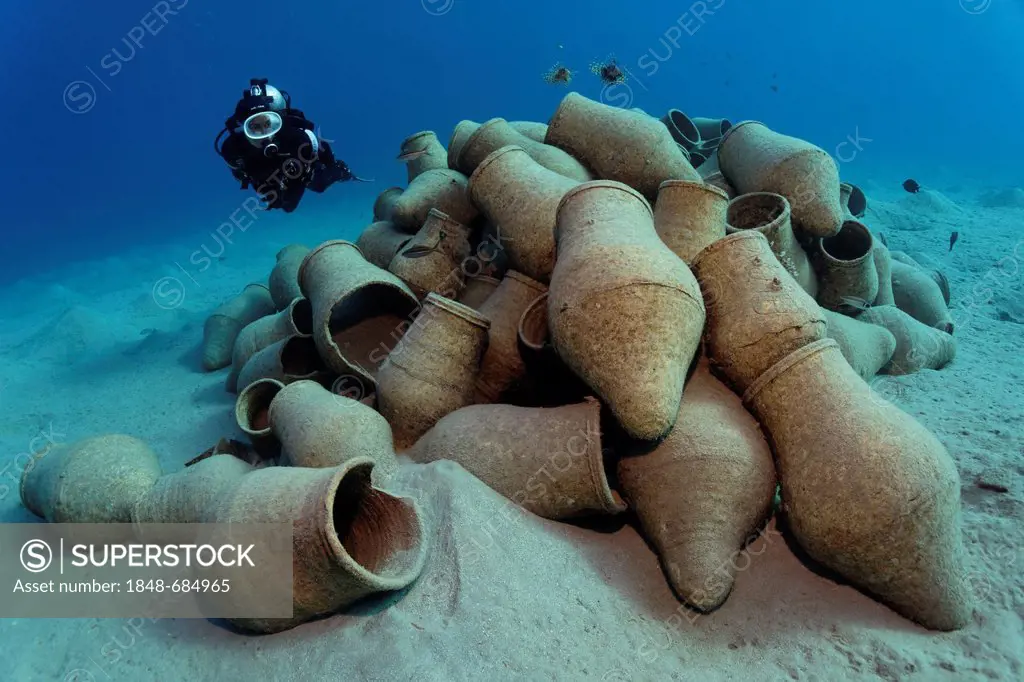 Diver looking at amphoras on a sandy bottom, Makadi Bay, Hurghada, Egypt, Red Sea, Africa