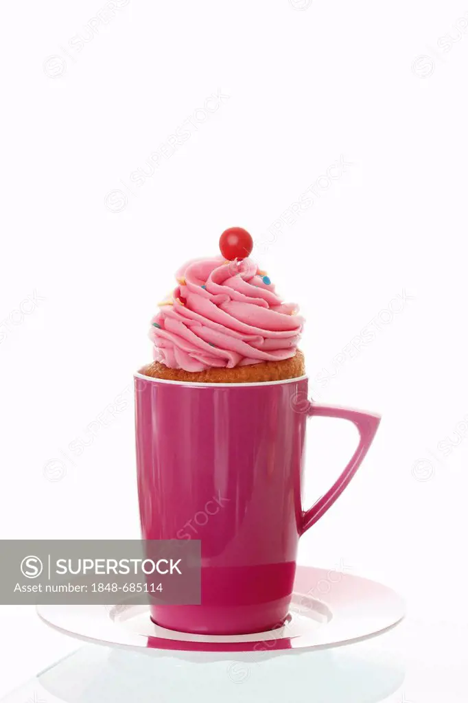 Cupcake with strawberry butter cream in pink coffee mug