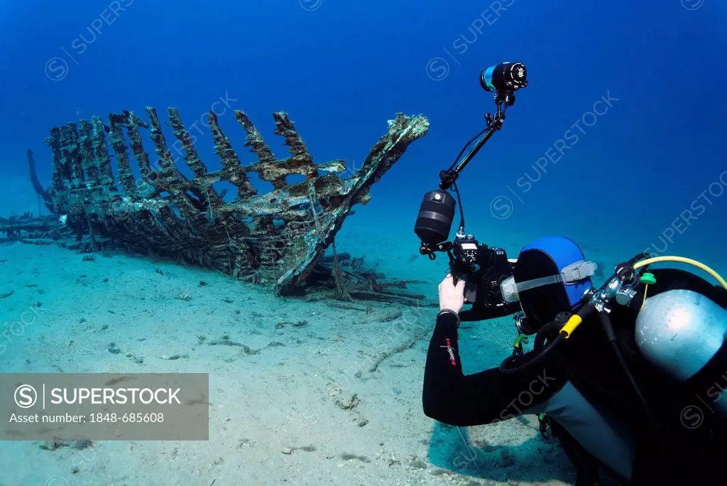 Underwater photographer taking photo of a wooden ship wreck, Makadi Bay, Hurghada, Egypt, Red Sea, Africa
