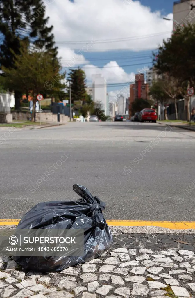 Garbage bag waiting by the roadside of a major city to be picked up, Curitiba, Parana, Brazil, South America, PublicGround
