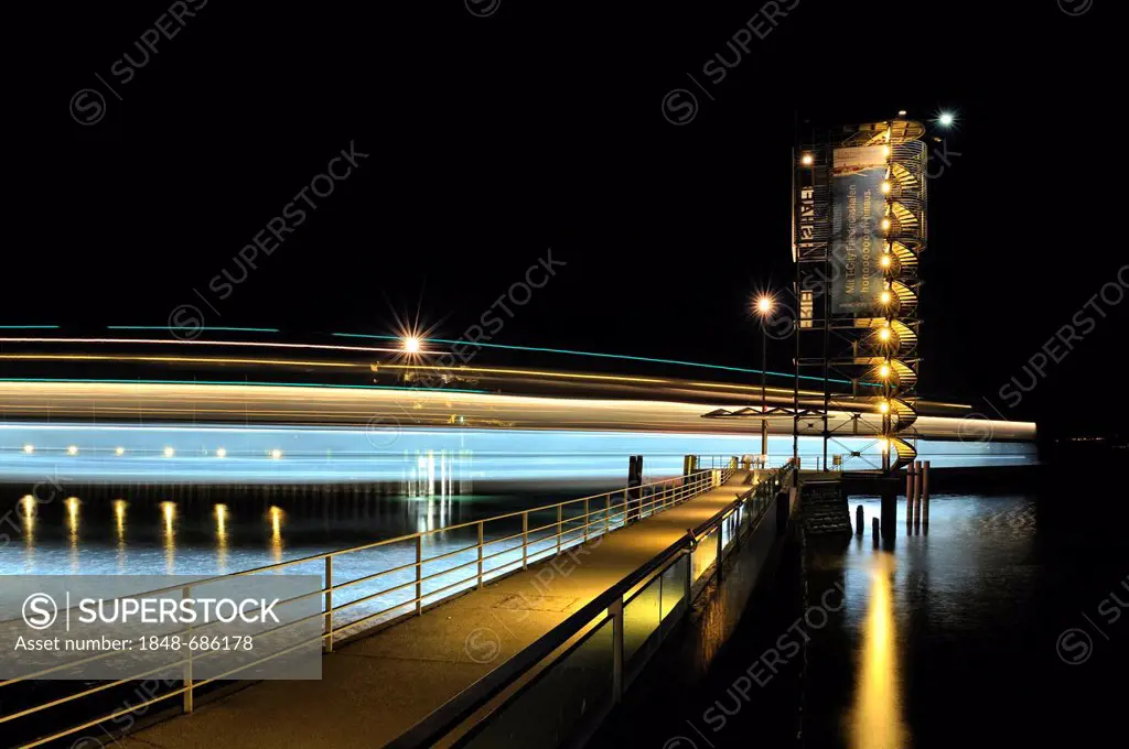 Light trace of the moving Euregia ferry and the illuminated Molenturm tower in the ferry port of Friedrichshafen, Bodenseekreis district, Baden-Wuertt...