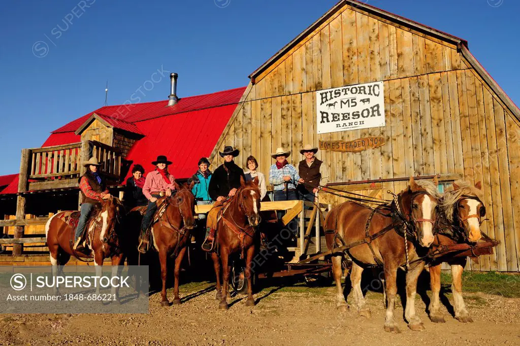 Cowboys and cowgirls with horses in front of a barn, Saskatchewan, Canada, North America