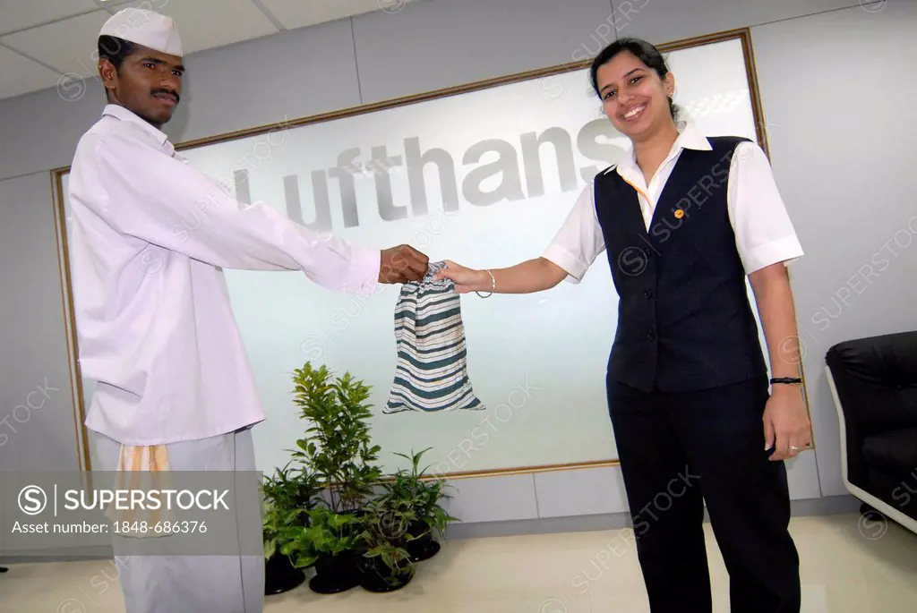 Dabba wallah or food deliverer delivering Dabbas or food containers to a member of the Lufthansa office at Nariman Point, Mumbai, India, Asia