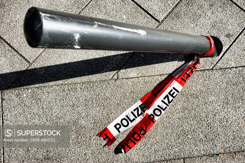 Police barrier tape on a bent bollard, Germany, Europe