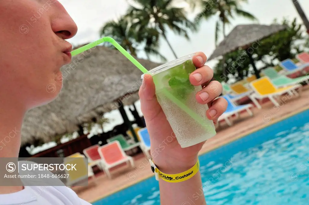 All-inclusive wristband and a mojito cocktail in the hand of a tourist, Hotel Costasur, Playa Ancón, near Trinidad, Cuba, Caribbean