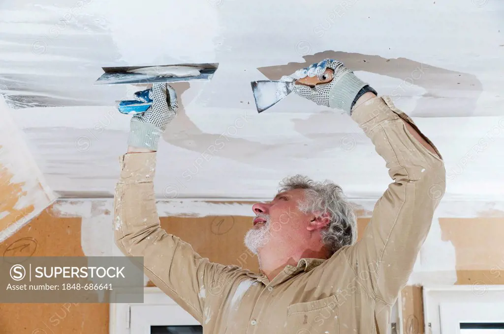Craftsman plastering a ceiling