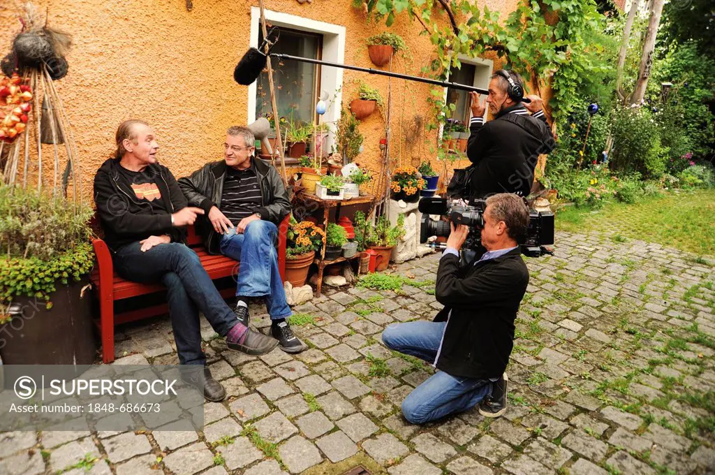 Franz Xaver Gernstl, 2nd left, director of TV series Gernstl Unterwegs, interviewing the art restorer Stephan Muehlbauer, left, Regensburg, Bavaria, G...