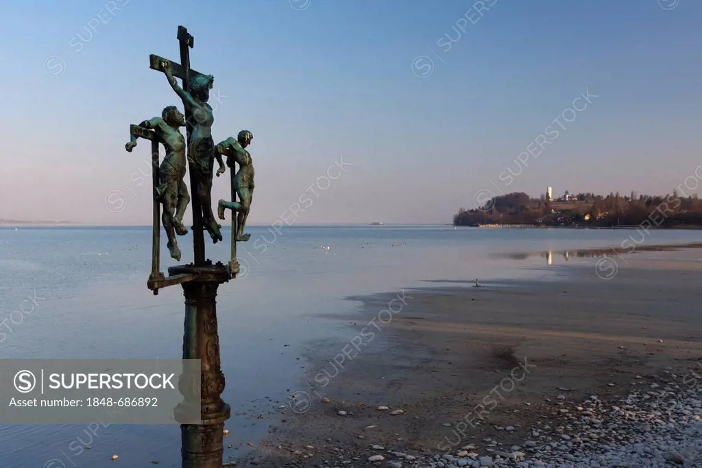 Crucifixion group Christ nailed to the cross at the entrance to Insel Mainau Island, view across Lake Constance towards Konstanz-Egg, Baden-Wuerttembe...