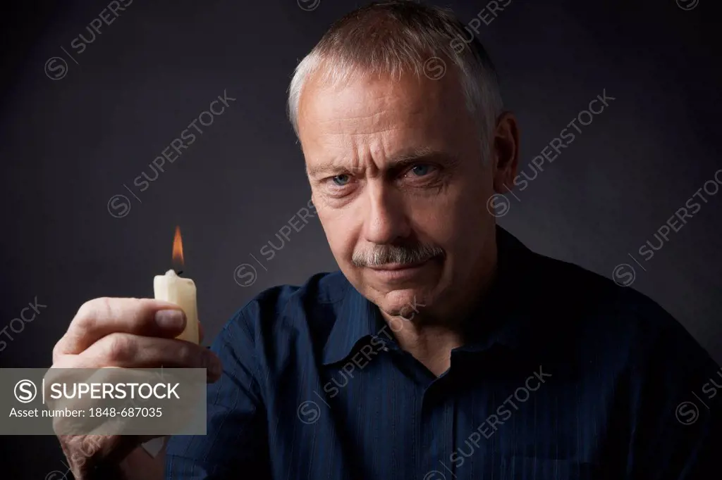 Man with burning candle