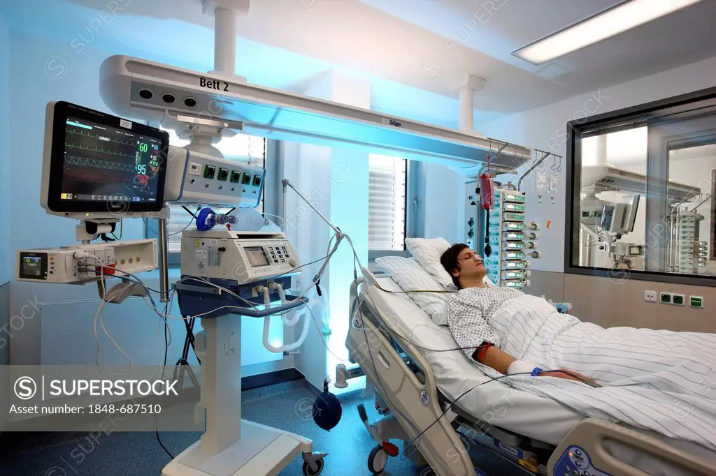 Patient lying in a special bed, being given artificial respiration through the nose, intensive care unit, hospital