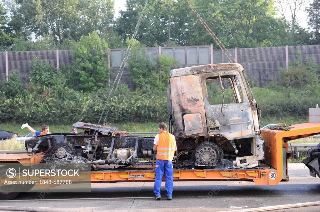 A burned-out truck engine on a flatbed truck for removal on the A8 motorway, Stuttgart, Baden-Wuerttemberg, Germany, Europe