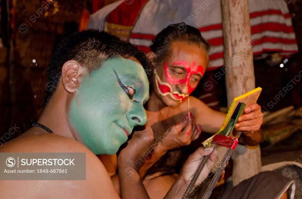 The make-up of the Kathakali character Kathalastri is being applied, Perattil, Kerala, India, Asia