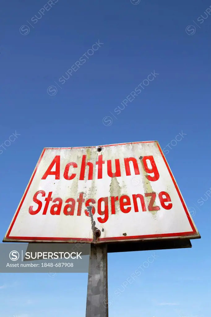 Sign, Achtung Staatsgrenze, German for Attention! National border, against a blue sky