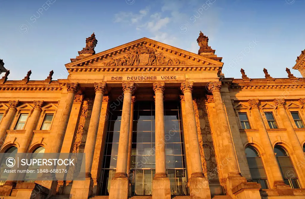 Evening light on the Reichstag German Parliament, words Dem Deutschen Volke or To the German People and relief in the tympanum over the main portal, G...