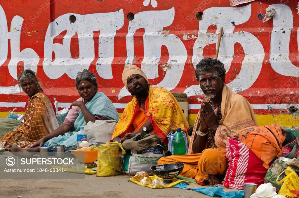 Sadhus, Holy Men of India, waiting for charity at the bathing ghat in Rameshwaram, Tamil Nadu, India, Asia