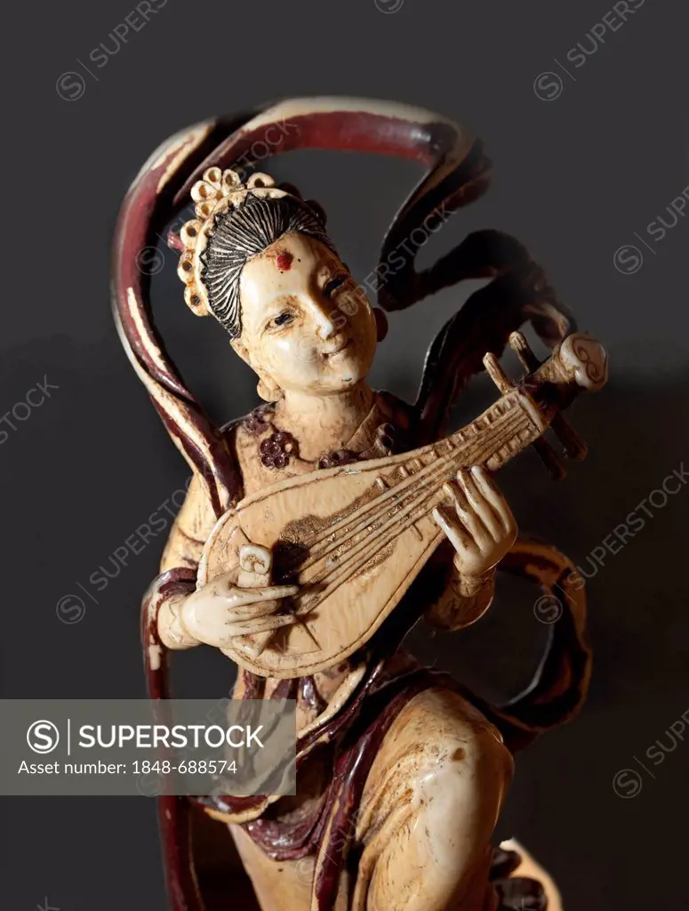 Carved ivory figurine, woman playing a pipa, a traditional Chinese lute, East Asia exhibition at the Haus Kemnade moated castle, Hattingen, North Rhin...