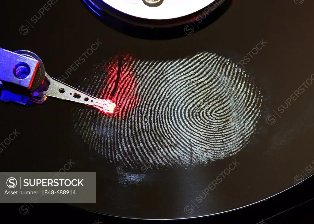 Computer hard drive, opened, read-write head on the disk, fingerprint on the disc, digital fingerprint, symbolic image