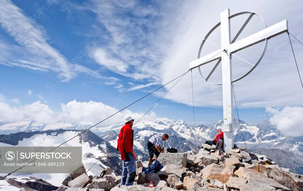 Climbers on the summit cross, Mt. Vertainspitze, Ortles area, in the Back Mount Zebru, South Tyrol, Italy, Europe