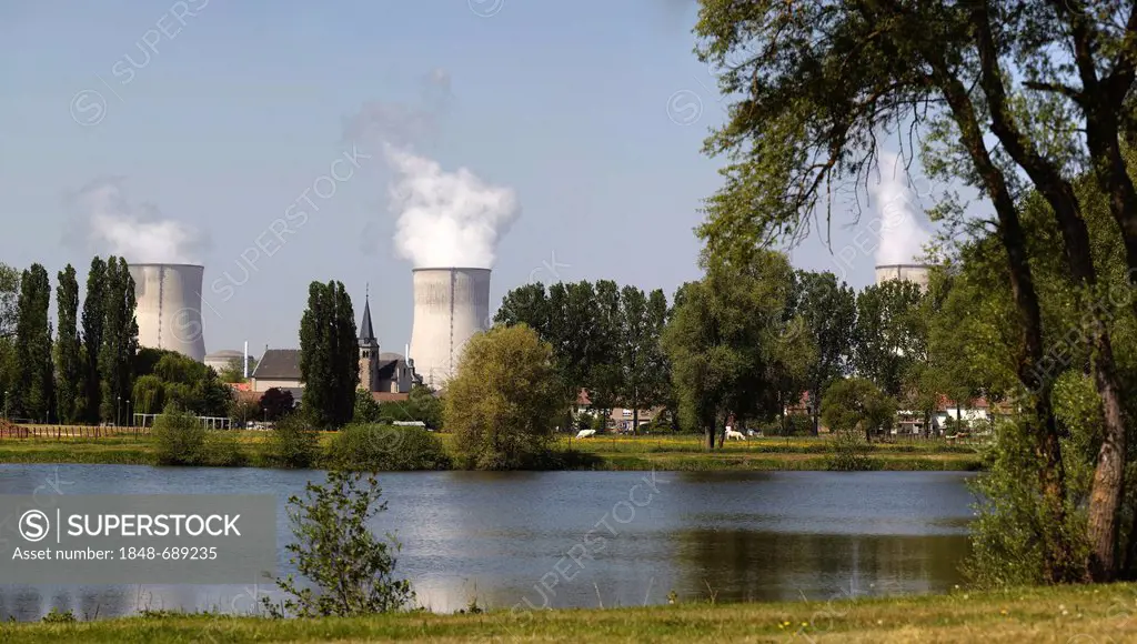 Two cooling towers of the French Cattenom Nuclear Power Plant, the church of Cattenom standing between the cooling towers, Lorraine region, France, Eu...