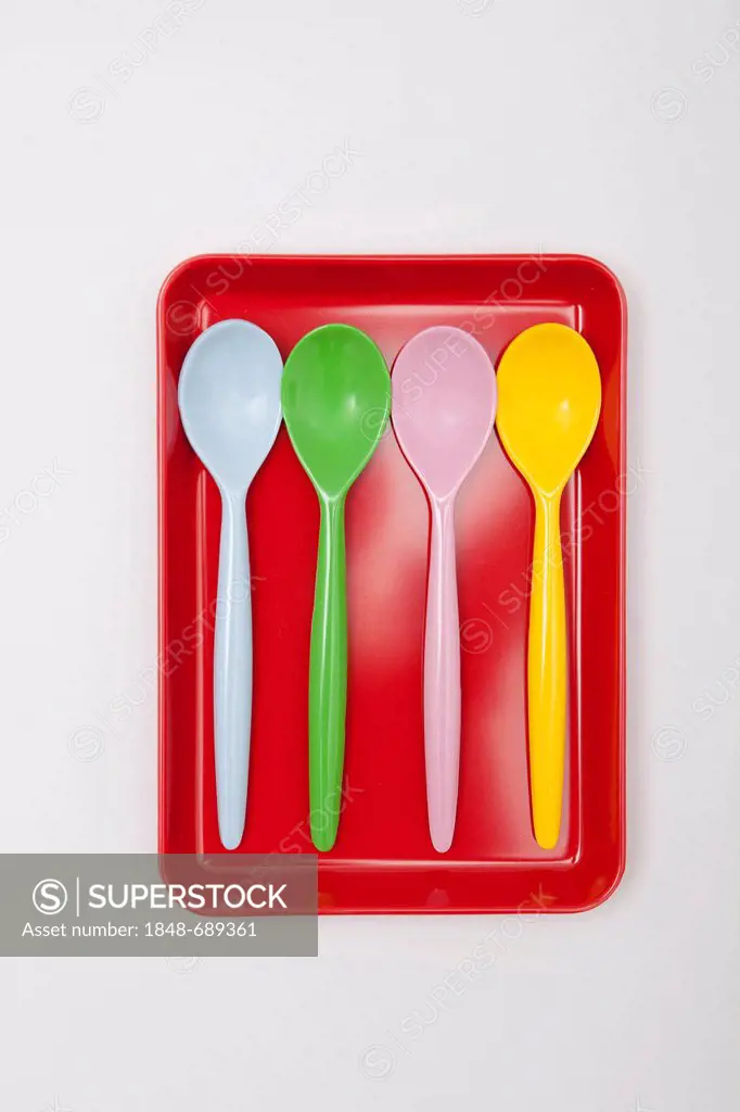 Colorful plastic spoons, egg spoons on a tray