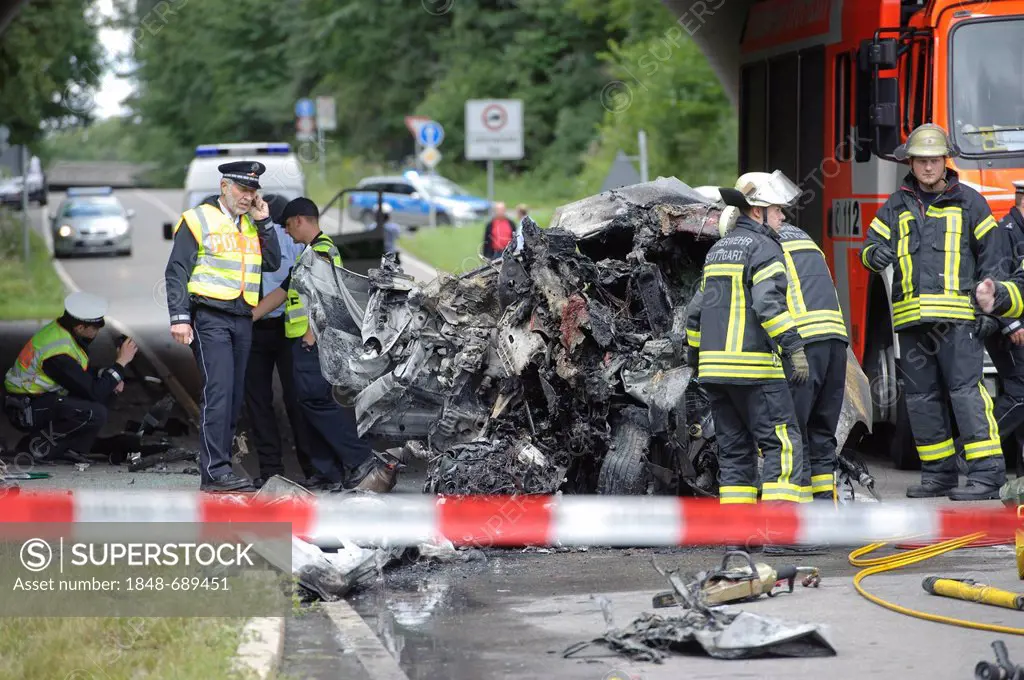 Police officers and firefighters, forensic unit preserving evidence after fatal traffic accident of the wreckage of an Audi A3 car which was destroyed...