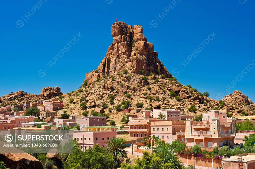 Small village of Aguard Oudad with colourfully painted houses in front of the imposing rocks of Chapeau Napoleon, Napoleon's Hat, Tafraoute, Anti-Atla...