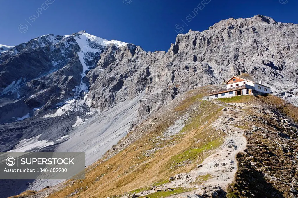 View of the Tabarettahuette mountain lodge, north face of Ortler mountain at the back, during the ascent to the Tabaretta fixed rope route, region of ...