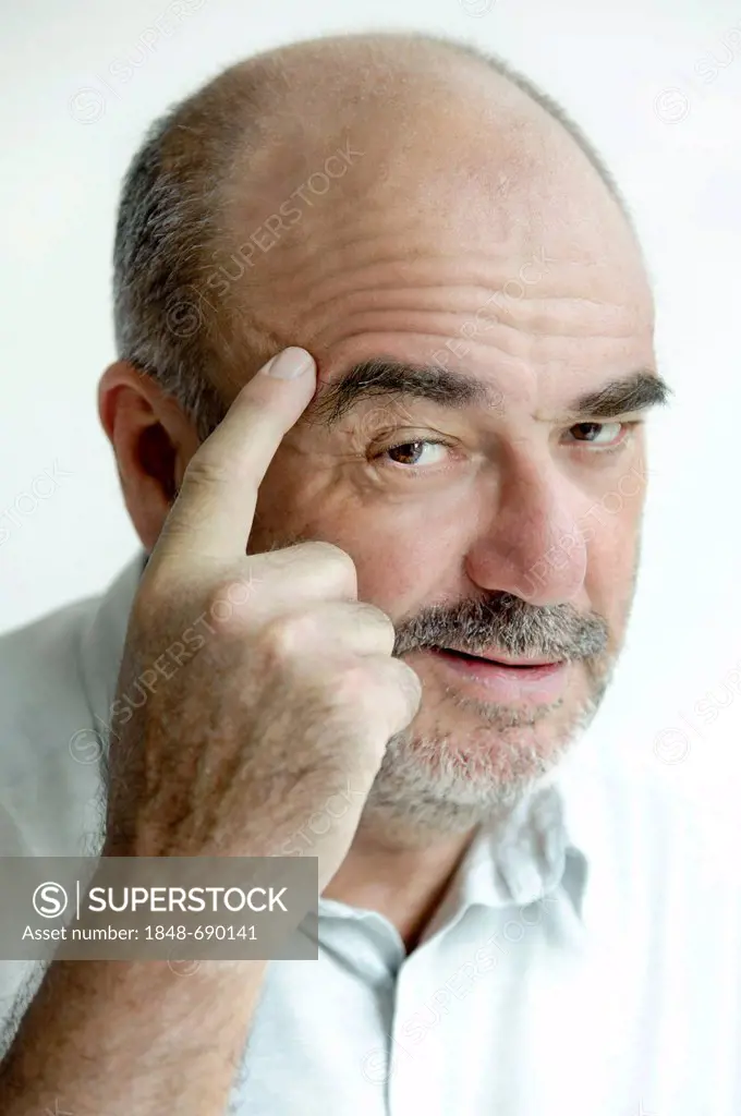 Man tapping his forehead with his finger
