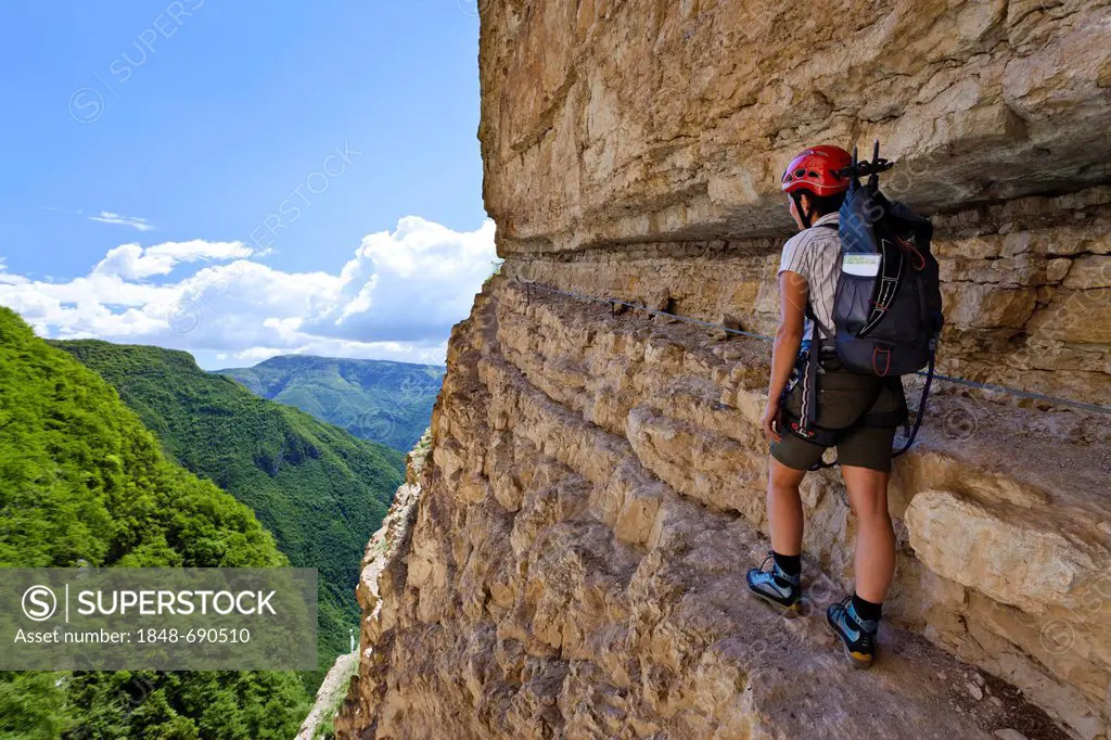 Climber on the Gerardo Sega fixed rope route on Mounte Baldo mountain above Avio, Lake Garda region, province of Trento, Italy, Europe