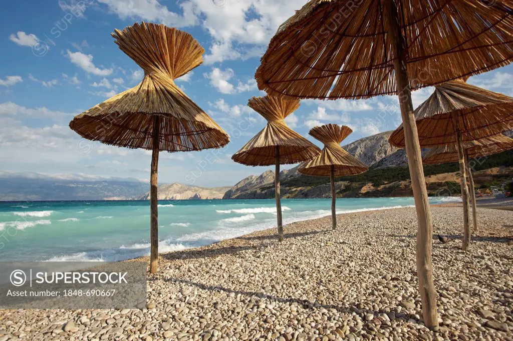 Parasols on Baska beach on the island of Krk, Croatia, Europe