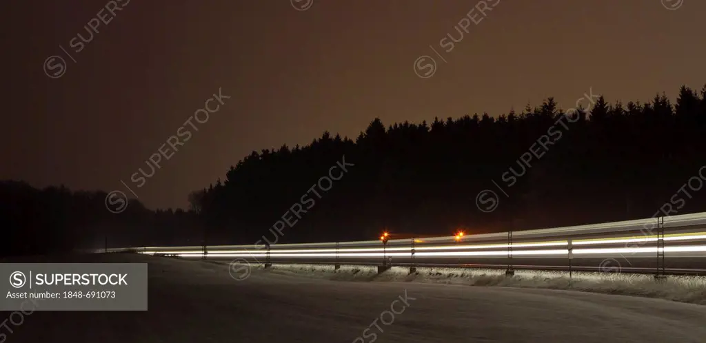 Train as a light trace in winter at night, Beimerstetten, Baden-Wuerttemberg, Germany, Europe