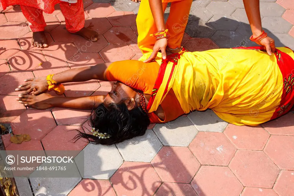 Pilgrim at the Hindu festival Thaipusam rolling on the ground to the Batu Caves limestone caves and temples, Kuala Lumpur, Malaysia, Southeast Asia, A...