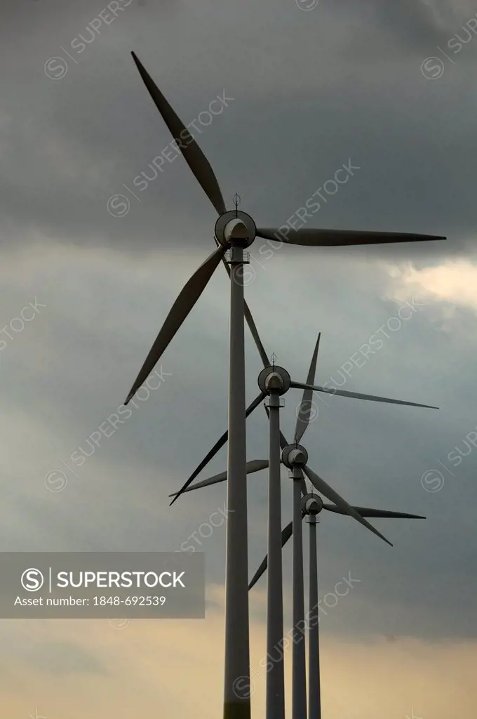 Four wind turbines against a grey sky, Harmshagen, Mecklenburg-Western Pomerania, Germany, Europe