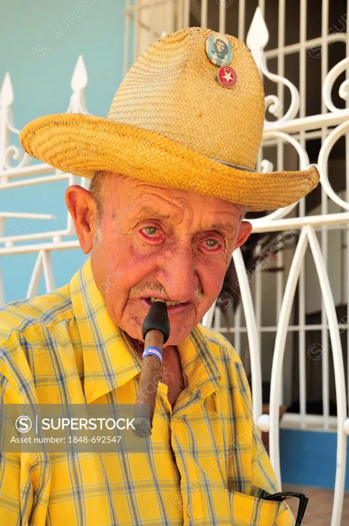 Cuban with a cigar in the historic district of Trinidad, Cuba, Caribbean