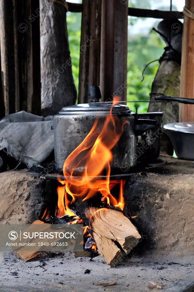 Pressure cooker on stove made of clay with a wood fire, Acampamento 12 de Otubro landless camp, Movimento dos Trabalhadores Rurais sem Terra, a Brazil...
