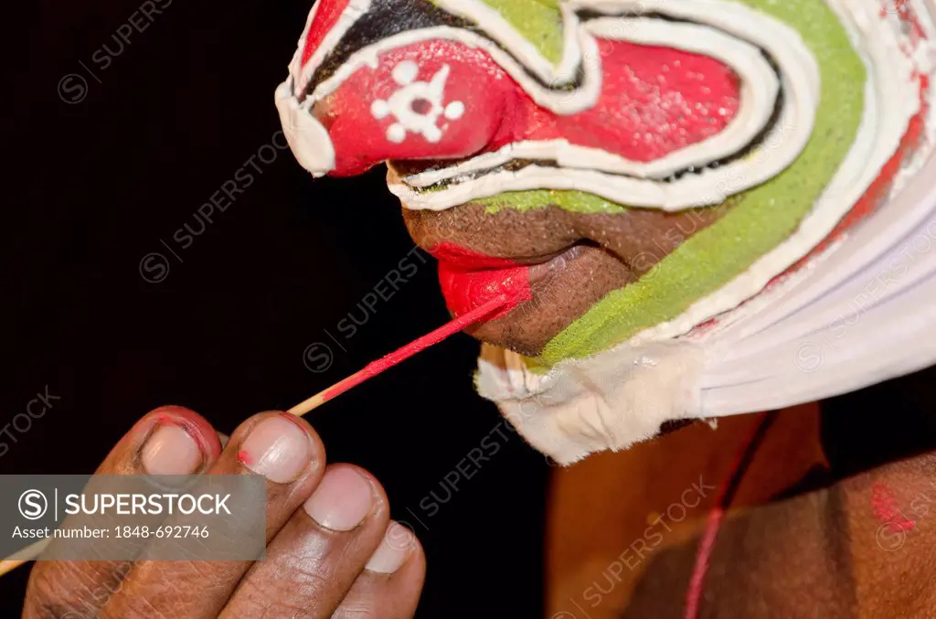 The make-up of the Kathakali character Ravana is being applied, Perattil, Kerala, India, Asia