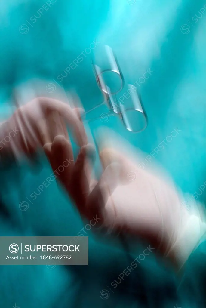 Surgery, scrub nurse passing a hemostatic clamp or arterial forceps to a surgeon, close-up