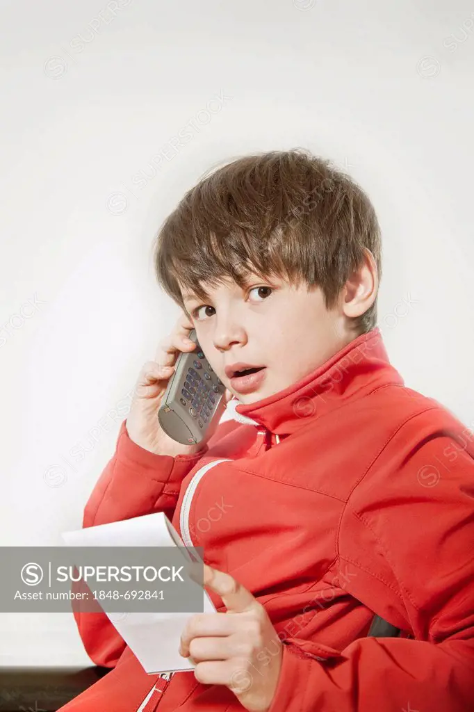 Boy speaking on a cordless phone