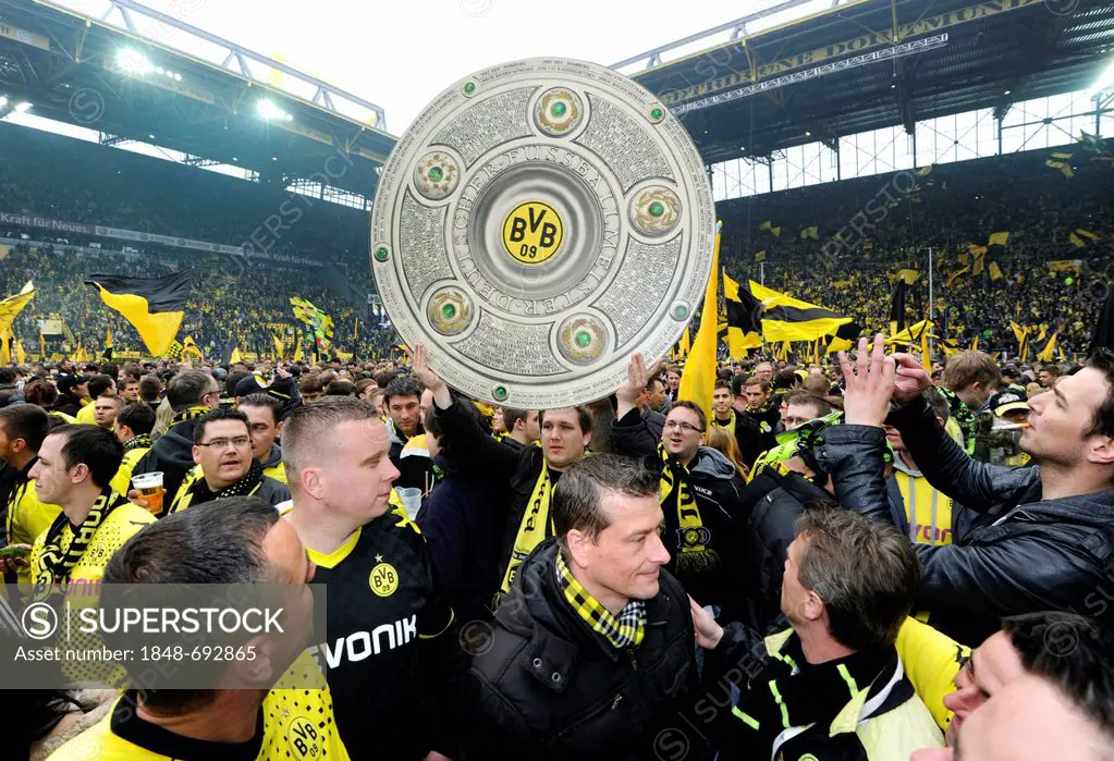 Football club BVB Borussia Dortmund fans on the pitch with a dummy of the league cup trophy, after match Borussia Dortmund vs SC Freiburg (4:0), Signa...