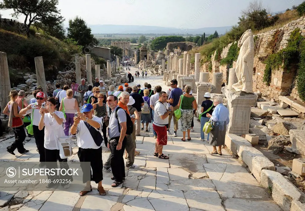 Tourists in Ephesus, Efes, UNESCO World Heritage Site, view from the Curetes Street to the Library of Celsus at back, Selcuk, Lycia, Southwest Turkey,...