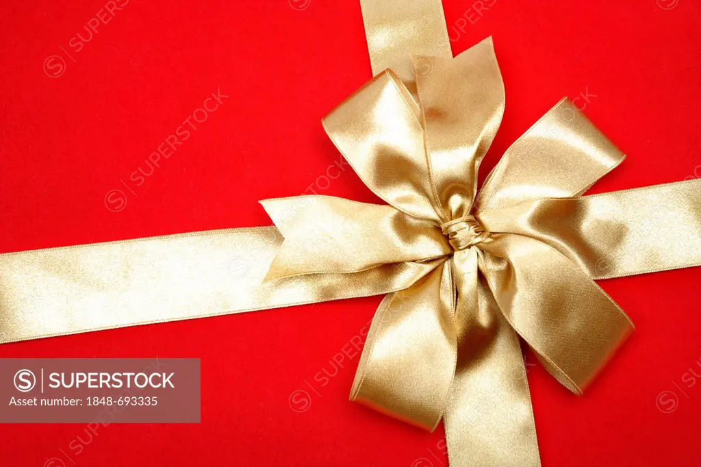 Red Christmas gift with a golden bow