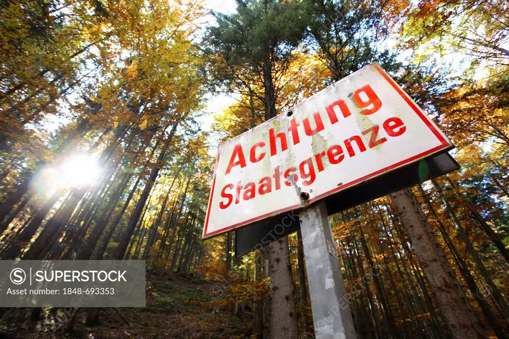 Sign in a forest in autumn, Achtung Staatsgrenze, German for Attention! National border