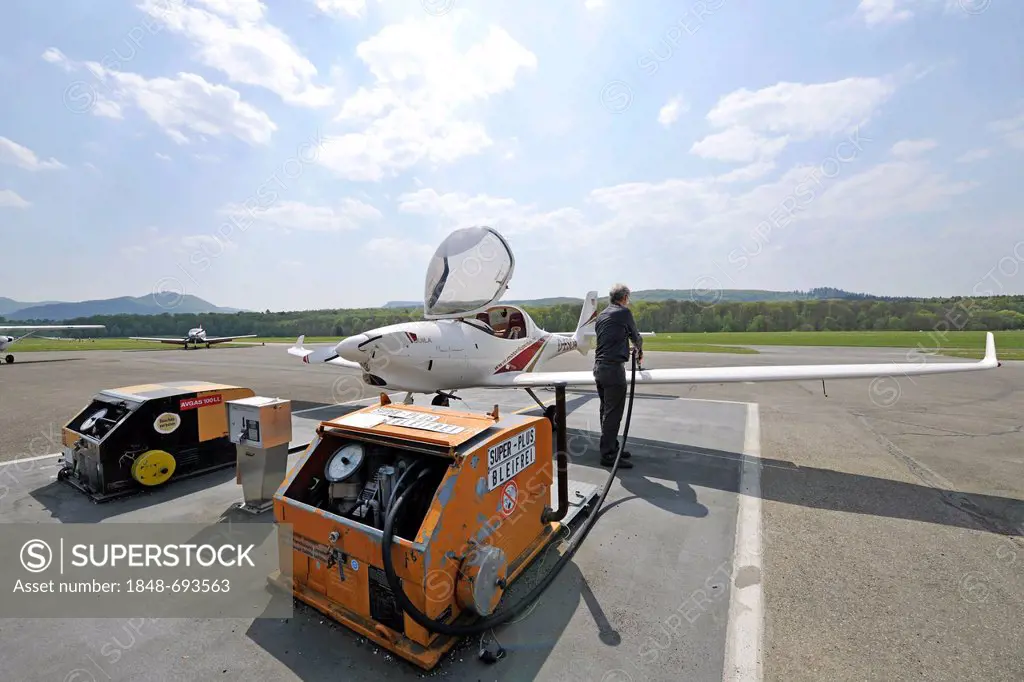Refueling the light aircraft D-ESOA Aquila A210 AT01 by its pilot, gas station on Airport Hahnweide, Kirchheim unter Teck, Baden-Wuerttemberg, Germany...