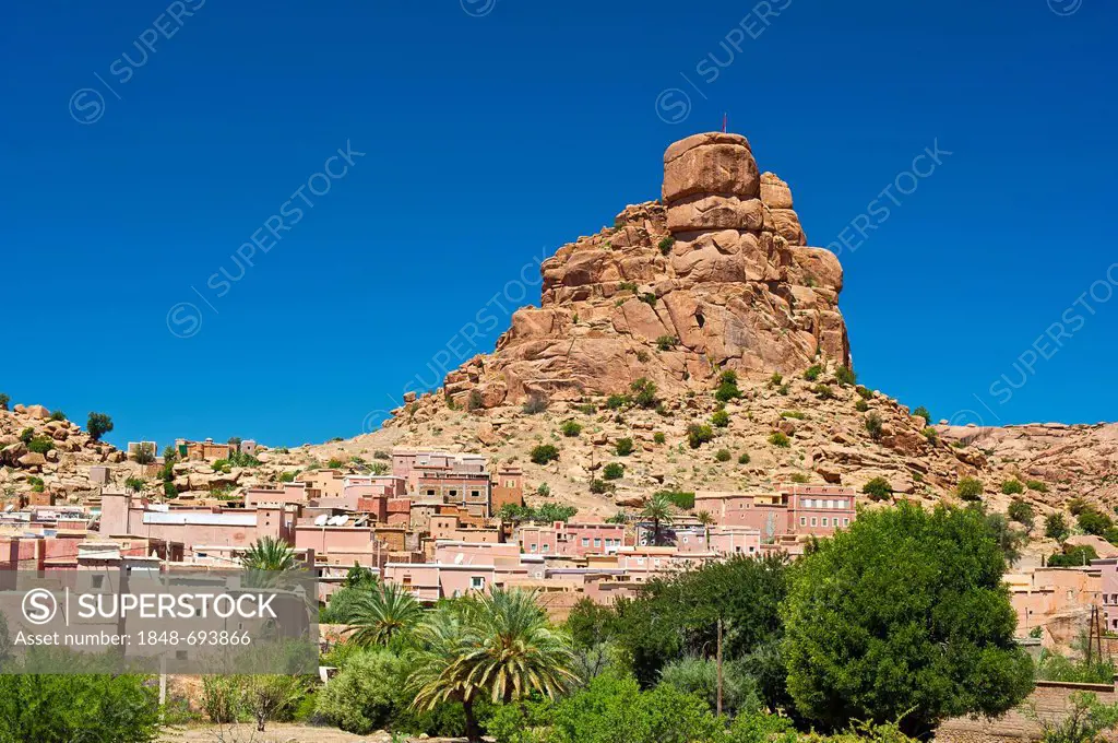 Small village of Aguard Oudad with colourfully painted houses in front of the imposing rocks of Chapeau Napoleon, Napoleon's Hat, Tafraoute, Anti-Atla...