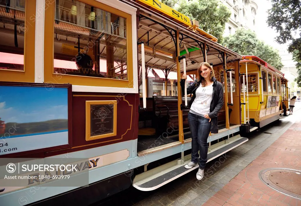 Young woman posing on a cable car, cable tramway, Powell and Hyde Street, San Francisco, California, United States of America, USA, PublicGround