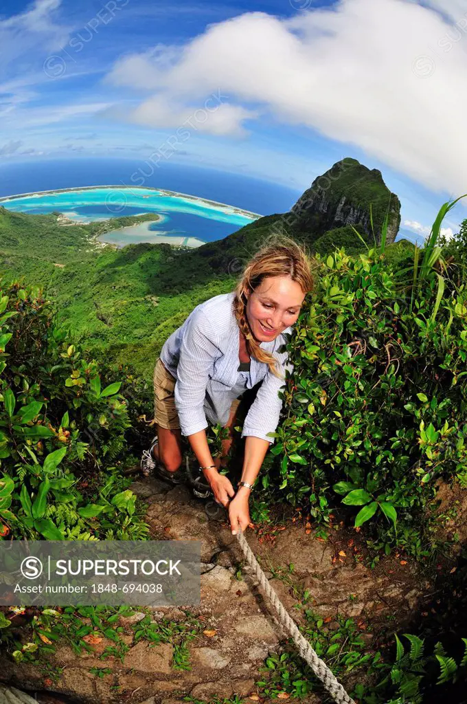 Woman hiking on Mount Pahia, Bora Bora, Leeward Islands, Society Islands, French Polynesia, Pacific Ocean