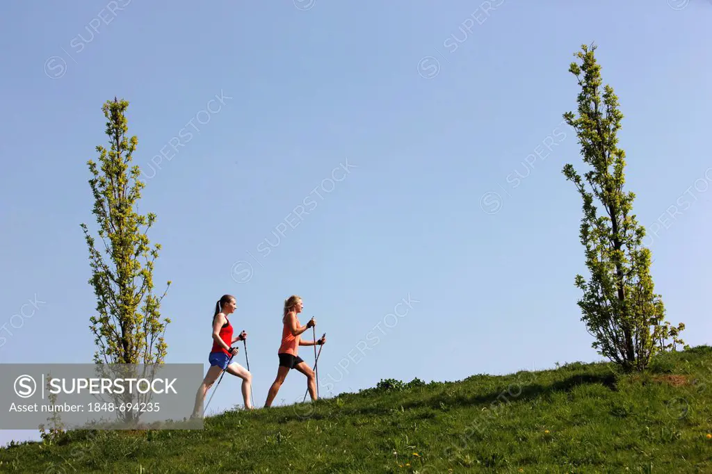 Young women, 25 - 30 years, Nordic walking with walking sticks
