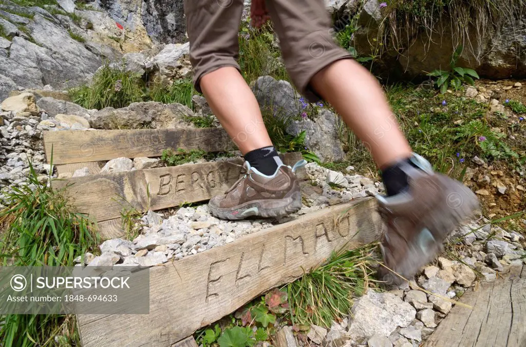 Hiker climbing a mountain, detailed view of the legs, descending past Klamml towards Gruttenhuette mountain lodge, Ellmauer Halt, Wilder Kaiser mounta...