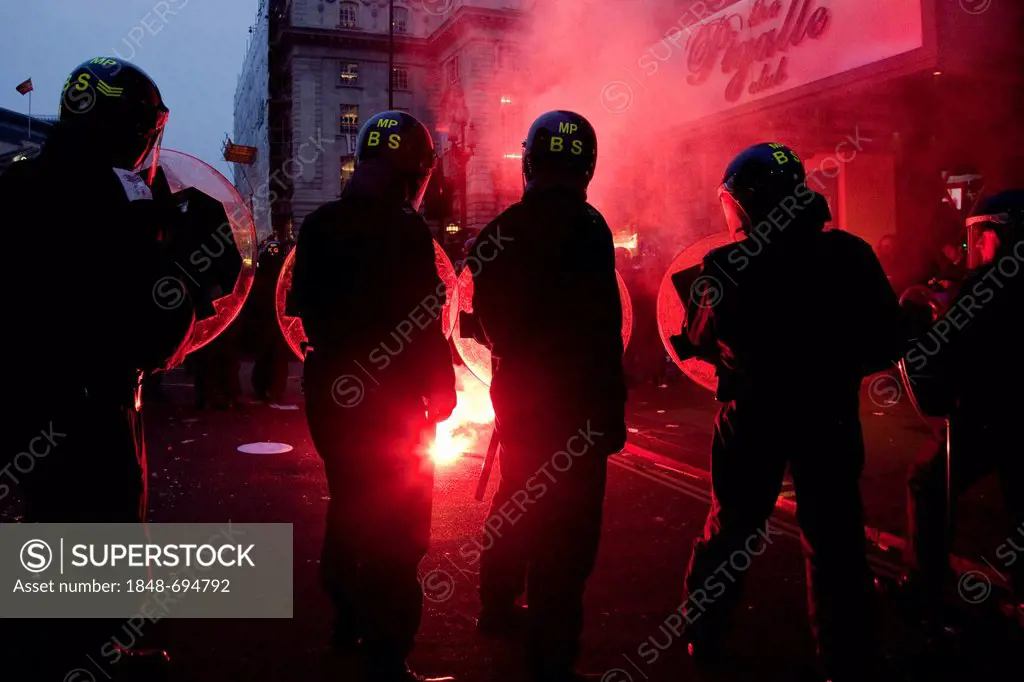 Protesters and riot police officers clash at anti budget cuts demonstration, London, England, United Kingdom, Europe