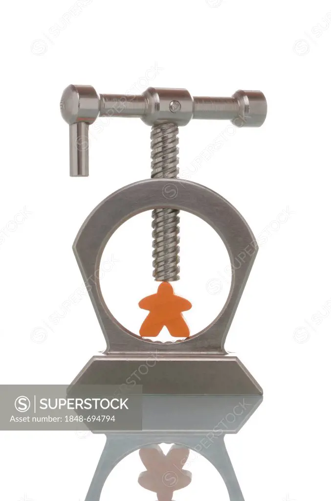 Toy figurine clamped in a vice, symbolic image for pressure to perform